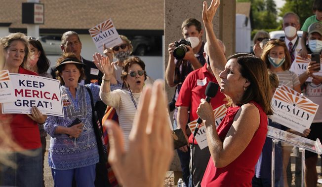 Arizona Republican Sen. Martha McSally sings &amp;quot;God Bless America&amp;quot; as she campaigns at Arizona Republican Party Headquarters Monday, Nov. 2, 2020, in Phoenix. McSally is running against Democratic candidate Mark Kelly in the election set for tomorrow. (AP Photo/Ross D. Franklin)