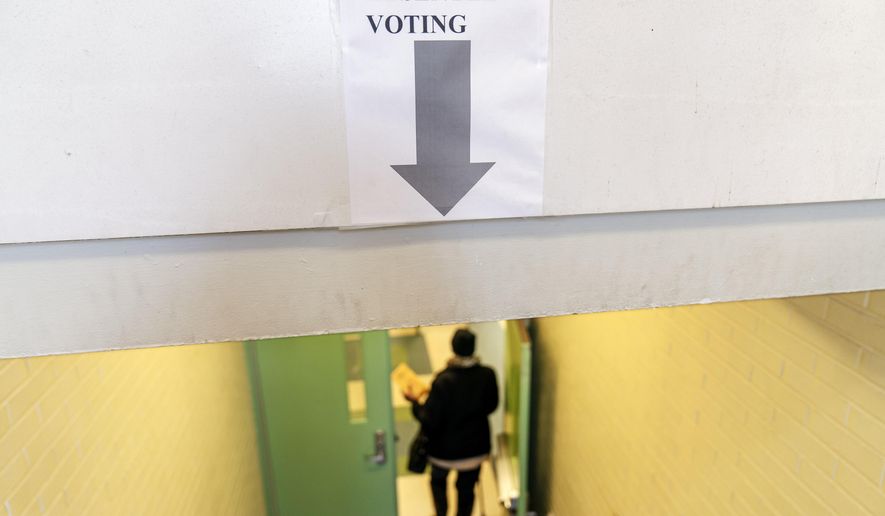 A voters enters to fill out a ballot on the last day of early absentee voting before tomorrow's general election at the Northwest Activities Center in Detroit, Monday, Nov. 2, 2020. Down to the wire with the threat of court battles looming, supporters of former Vice President Joe Biden scrambled Monday to rally swing-state voters to drop off ballots, visit precincts in person and ensure their votes are counted. (AP Photo/David Goldman)