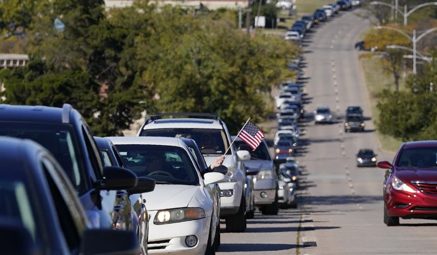 FILE - In this Thursday, Oct. 29, 2020 file photo a long line of cars is pictured outside the Oklahoma County Election Board for early voting Thursday, Oct. 29, 2020, in Oklahoma City. Oklahoma smashed records for early voting this year and has experienced a surge in voter registration ahead of Tuesday's election, state officials reported. (AP Photo/Sue Ogrocki, File)