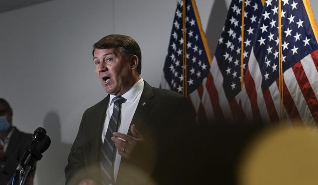 In this June 16, 2020, photo, Sen. Mike Rounds, R-S.D., takes questions from reporters about proposed policing reforms after President Donald Trump signed an executive order on police reform on Capitol Hill in Washington, Tuesday, June 16, 2020. (AP Photo/J. Scott Applewhite) **FILE**