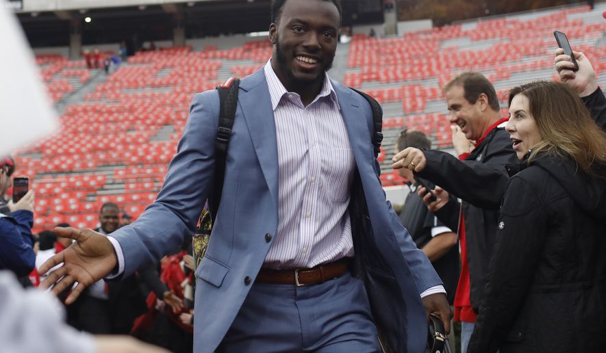 FILE - In this Nov. 23, 2019, file photo, Georgia defensive back Richard LeCounte (2) is greeted by fans before an NCAA football game against Texas A&M in Athens, Ga. Just in time for a key SEC East game against No. 8 Florida, No. 5 Georgia has to adjust to a rash of new injuries on defense after a rough weekend capped by safety Richard LeCounte avoiding life-threatening injuries in an accident while riding his motorcycle. (Joshua L. Jones/Athens Banner-Herald via AP, File)