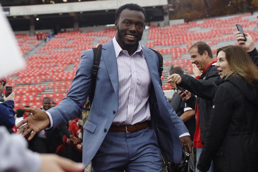 FILE - In this Nov. 23, 2019, file photo, Georgia defensive back Richard LeCounte (2) is greeted by fans before an NCAA football game against Texas A&M in Athens, Ga. Just in time for a key SEC East game against No. 8 Florida, No. 5 Georgia has to adjust to a rash of new injuries on defense after a rough weekend capped by safety Richard LeCounte avoiding life-threatening injuries in an accident while riding his motorcycle. (Joshua L. Jones/Athens Banner-Herald via AP, File)