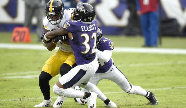 Pittsburgh Steelers wide receiver JuJu Smith-Schuster, left, is stopped short of the goal line by Baltimore Ravens free safety DeShon Elliott (32) and cornerback Marlon Humphrey during the second half of an NFL football game, Sunday, Nov. 1, 2020, in Baltimore. (AP Photo/Gail Burton)
