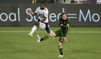 Vancouver Whitecaps forward Cristian Dajome, left, puts a shot on goal as Portland Timbers defender Jorge Villafana defends during the first half of an MLS soccer match in Portland, Ore., Sunday, Nov. 1, 2020. (AP Photo/Steve Dykes)