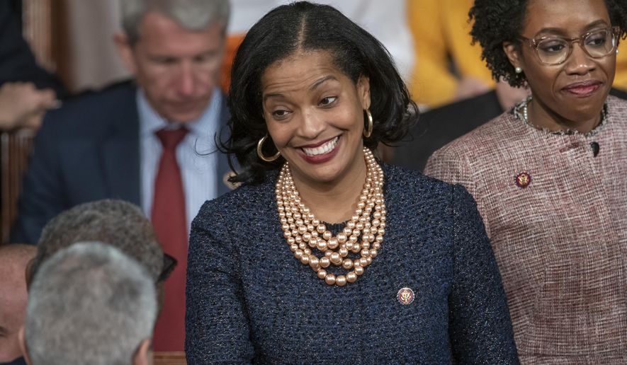FILE - Rep. Jahana Hayes, D-Conn., center, smiles on the first day of the 116th Congress, Thursday, Jan. 3, 2019, on the Capitol in Washington. Hayes will face Republican David Sullivan for Connecticut's 5th Congressional District in the 2020 elections. (AP Photo/J. Scott Applewhite, File)