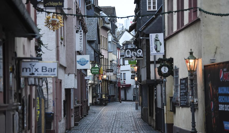 The Klappergasse in Frankfurt's pub district of Alt-Sachsenhausen is deserted in Frankfurt, Germany, Monday, Nov.2, 2020. A four-week partial lockdown has begun all over Germany to slow down the spread of the corona virus.(Arne Dedert/dpa via AP)