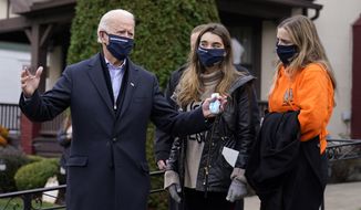 Democratic presidential candidate former Vice President Joe Biden speaks to reporters after he visited his childhood home in Scranton, Pa., Tuesday, Nov. 3, 2020, as granddaughters Natalie, center, and Finnegan listen. (AP Photo/Carolyn Kaster)