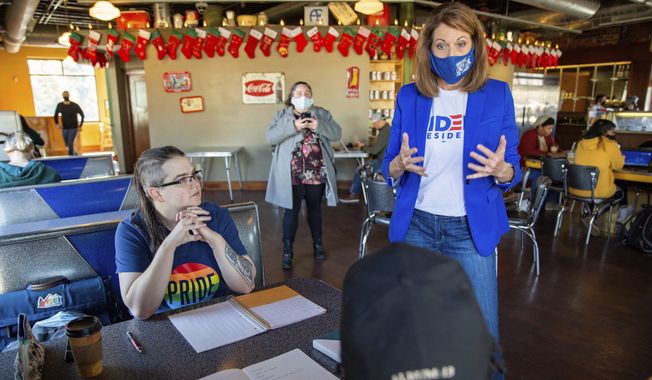 Rep. Cindy Axne, D-Iowa, speaks with Jean Riehm and Julian Seay in Des Moines, Iowa, Tuesday, Nov. 3, 2020. (Zach Boyden-Holmes/The Des Moines Register via AP)