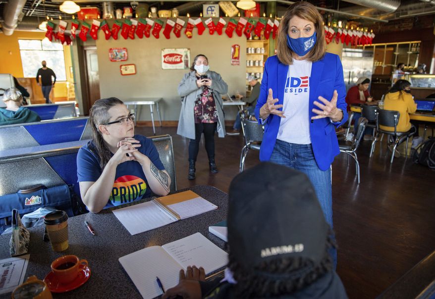 Rep. Cindy Axne, D-Iowa, speaks with Jean Riehm and Julian Seay in Des Moines, Iowa, Tuesday, Nov. 3, 2020. (Zach Boyden-Holmes/The Des Moines Register via AP)