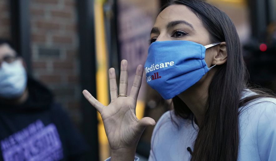 U.S. Rep. Alexandria Ocasio-Cortez, D-N.Y., speaks to members of her staff and volunteers who helped get out the vote and with her campaign, Tuesday, Nov. 3, 2020, outside her office in the Bronx borough of New York. (AP Photo/Kathy Willens)