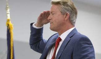 Congressman Roger Marshall salutes the flag during the Pledge of Allegiance at a GOP watch party at the Cyrus Hotel, Tuesday, Nov. 3, 2020 in downtown Topeka, Kan. Marshall is running against Barbara Bollier for the Kansas seat in the U.S. Senate. (Evert Nelson/The Topeka Capital-Journal via AP)
