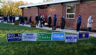 People line up outside a polling place to vote in the 2020 general election in the United States, Tuesday, Nov. 3, 2020, in Springfield, Pa. (AP Photo/Matt Slocum)