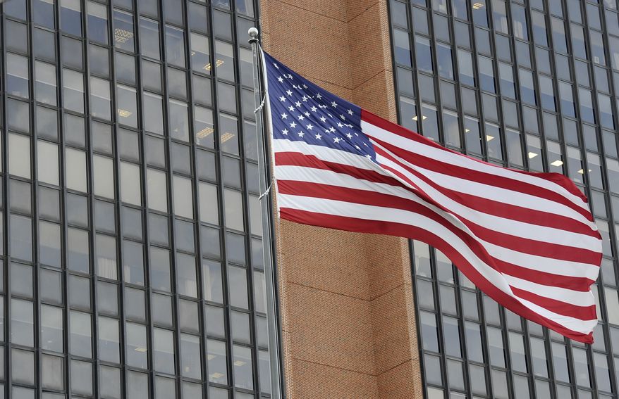 The American flag is seen at the James A. Byrne United States Courthouse, Tuesday, Nov. 3, 2020, in Philadelphia. (AP Photo/Michael Perez)