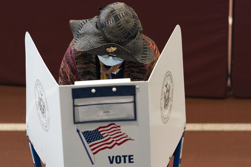 A voter marks her ballot during early voting at the Park Slope Armory YMCA, Tuesday, Oct. 27, 2020, in the Brooklyn borough of New York. (AP Photo/Mary Altaffer)
