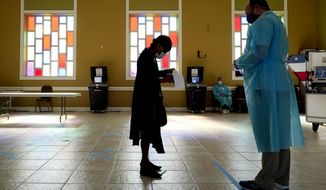 A woman waits to vote at the Cathedral of Praise church on Election Day Tuesday, Nov. 3, 2020, in Nashville, Tenn. (AP Photo/Mark Humphrey)