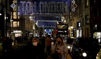 The Oxford Street Christmas lights stand lit up after being switched on today, in London, Monday, Nov. 2, 2020. British Prime Minister Boris Johnson on Saturday announced a new month-long lockdown for England that will start on Thursday, after being warned that without tough action a resurgent coronavirus outbreak will overwhelm hospitals in weeks. (AP Photo/Matt Dunham)