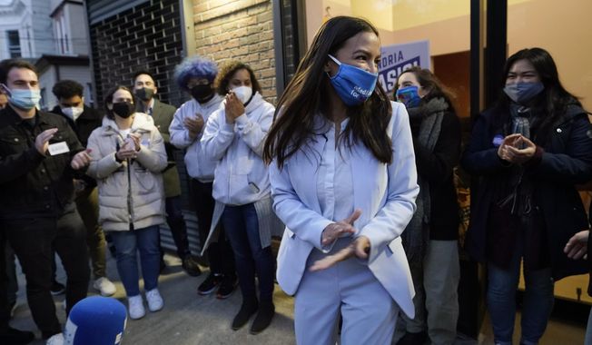 U.S. Rep. Alexandria Ocasio-Cortez, D-N.Y., speaks to members of her staff and volunteers who helped with her campaign and getting out the vote, Tuesday, Nov. 3, 2020, outside her office in the Bronx borough of New York. (AP Photo/Kathy Willens)
