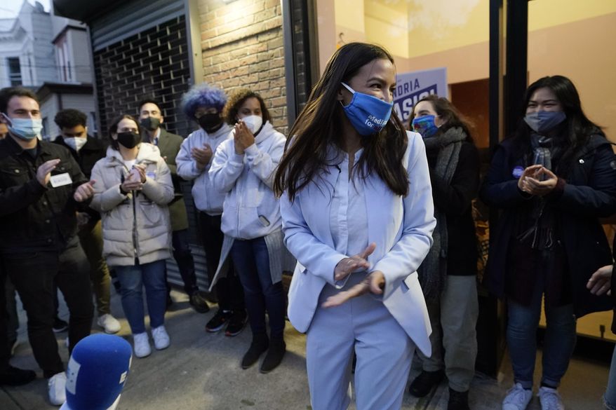 U.S. Rep. Alexandria Ocasio-Cortez, D-N.Y., speaks to members of her staff and volunteers who helped with her campaign and getting out the vote, Tuesday, Nov. 3, 2020, outside her office in the Bronx borough of New York. (AP Photo/Kathy Willens)