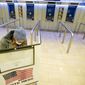 A voter marks her ballot during the first hour of voting in New York at Madison Square Garden, Tuesday, Nov. 3, 2020. (AP Photo/Mary Altaffer)