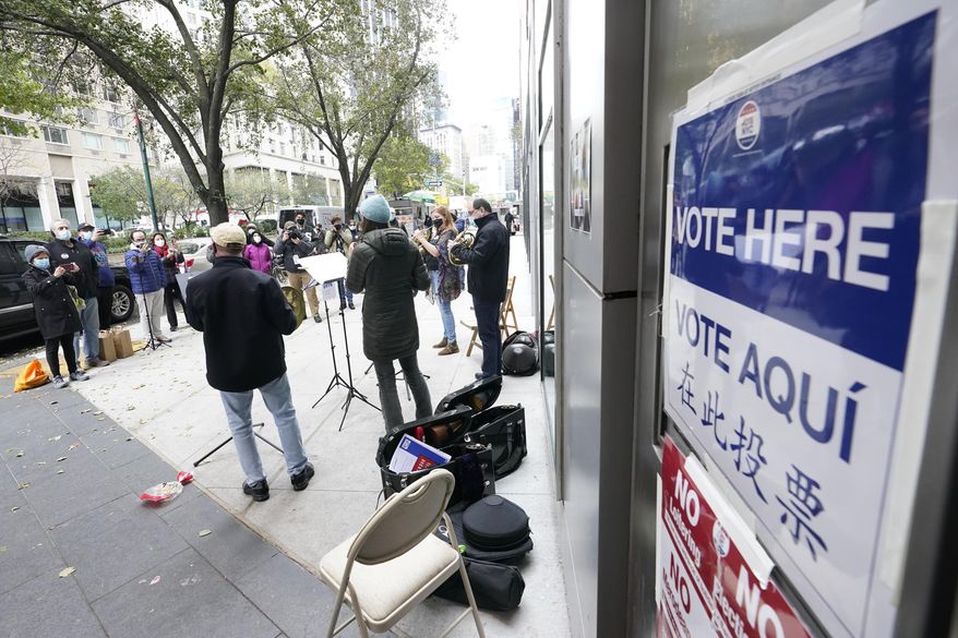 Members of the Metropolitan Opera Orchestra play for voters outside a polling place on Election Day, Tuesday, Nov. 3, 2020, in New York. (AP Photo/Mary Altaffer) ** FILE **
