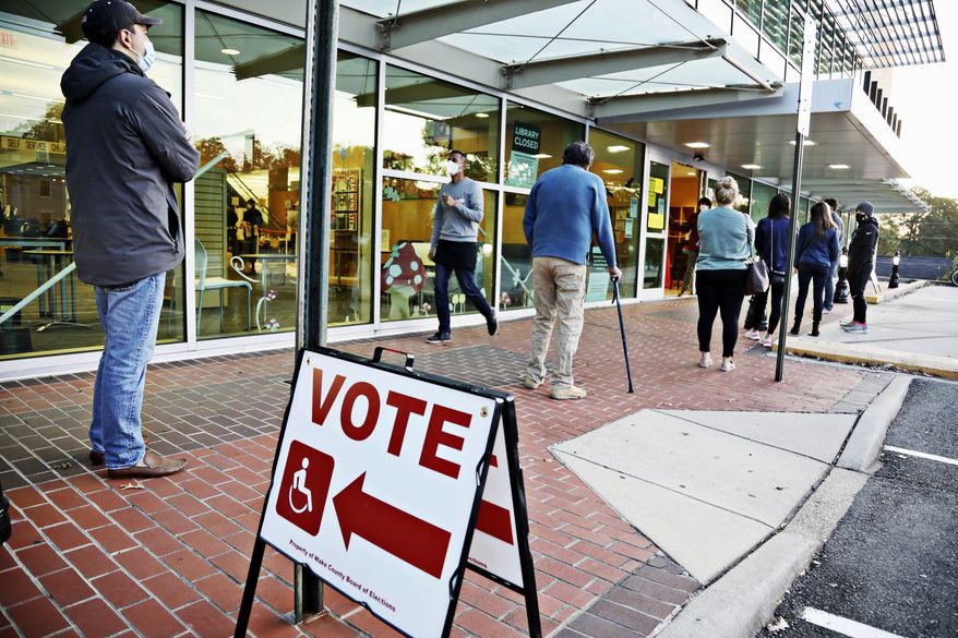 A steady line of voters wait outside of Cameron Village Library in Raleigh, N.C. early Tuesday morning, Nov. 3, 2020, to cast their ballot on Election Day.  (Juli Leonard/The News &amp;amp; Observer via AP)