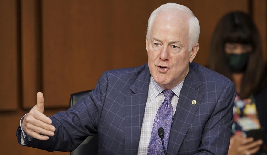 In this Oct. 15, 2020 file photo, Sen. John Cornyn, R-Texas, speaks with an aide during the confirmation hearing for Supreme Court nominee Amy Coney Barrett, before the Senate Judiciary Committee, on Capitol Hill in Washington. The incumbent Republican is running for the Senate for Texas. (Greg Nash/Pool via AP, File)