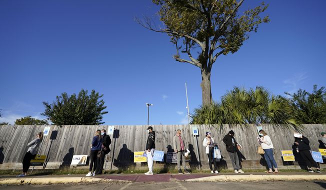 Voters wait in line outside a polling location on Election Day Tuesday, Nov. 3, 2020, in Houston. (AP Photo/David J. Phillip)