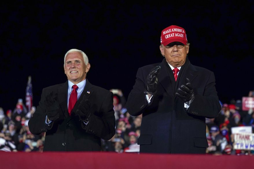 President Donald Trump arrives for a campaign rally at Gerald R. Ford International Airport, Monday, Nov. 2, 2020, in Grand Rapids, Mich., with Vice President Mike Pence (AP Photo/Evan Vucci)