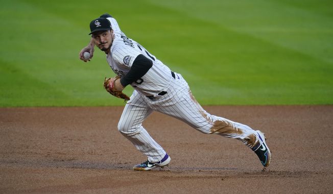 In this Sept. 11, 2020, file photo, Colorado Rockies third baseman Nolan Arenado throws to first during the first inning of the team&#x27;s baseball game against the Los Angeles Angels in Denver. Arenado won his eighth consecutive Gold Glove on Tuesday, Nov. 3, 2020. (AP Photo/David Zalubowski, File)  **FILE**