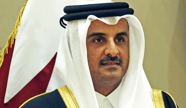 FILE - In this Tuesday, Dec. 5, 2017, file photo, Qatar&#x27;s emir, Sheikh Tamim bin Hamad Al Thani stands for a group photograph at the Gulf Cooperation Council summit in Kuwait. Qatar&#x27;s emir announced on Tuesday that the country will hold long-promised elections for its top advisory panel next year. (AP Photo/Jon Gambrell, File)