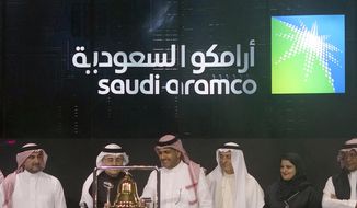 FILE - In this Dec. 11, 2019, file photo, Saudi Arabia&#39;s state-owned oil company Armco and stock market officials celebrate during the official ceremony marking the debut of Aramco&#39;s initial public offering (IPO) on the Riyadh&#39;s stock market, in Riyadh, Saudi Arabia. Saudi Arabia&#39;s oil and gas giant Aramco announced Tuesday, Nov. 3, 2020, third quarter profits of nearly $12 billion, a significantly higher net income from its dramatically lower second quarter earnings. (AP Photo/Amr Nabil, File)