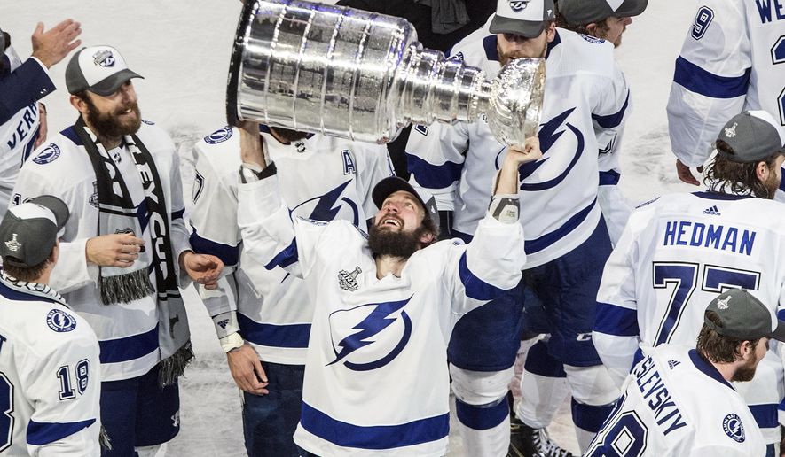 FILE - In this Sept. 28, 2020, file photo, Tampa Bay Lightning's Nikita Kucherov (86) hoists the Stanley Cup after defeating the Dallas Stars in the NHL Stanley Cup hockey finals, in Edmonton, Alberta. This has been a year for Tampa Bay sports like no other, though the area's three successful professional teams haven't had a chance to truly capitalize on the boom and connect with re-energized fan bases. It has been — and continues to be —- a missed opportunity because of the coronavirus pandemic. (Jason Franson/The Canadian Press via AP, File)