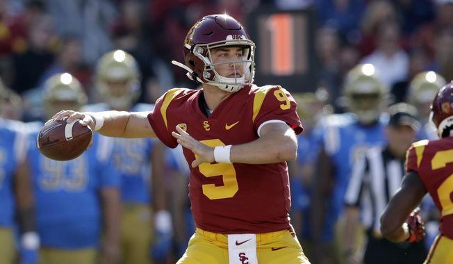FILE - In this Nov. 23, 2019, file photo, Southern California quarterback Kedon Slovis throws against UCLA during the first half of an NCAA college football game in Los Angeles. Last season's surprise starting quarterback could be one of the nation's best passers this fall, even if he won't catch anybody off guard this weekend when the No. 20 Trojans finally begin their regular season.(AP Photo/Marcio Jose Sanchez, File)