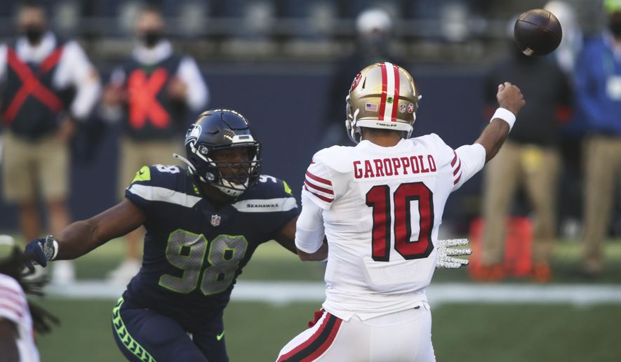 Seattle Seahawks defensive end Alton Robinson (98) pressures San Francisco 49ers quarterback Jimmy Garoppolo during the first half of an NFL football game, Sunday, Nov. 1, 2020, in Seattle. (AP Photo/Scott Eklund)