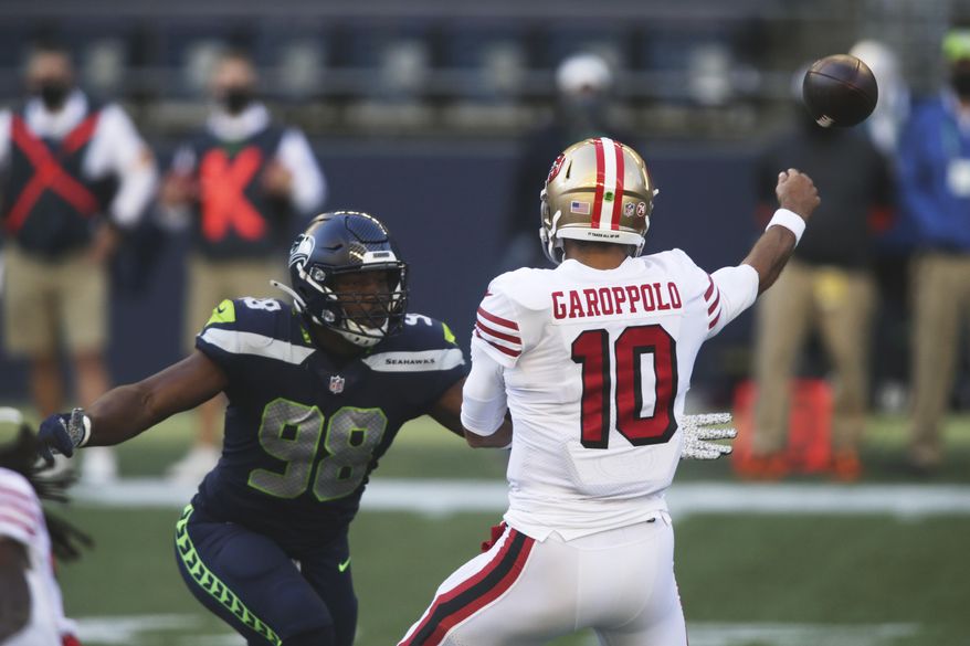 Seattle Seahawks defensive end Alton Robinson (98) pressures San Francisco 49ers quarterback Jimmy Garoppolo during the first half of an NFL football game, Sunday, Nov. 1, 2020, in Seattle. (AP Photo/Scott Eklund)