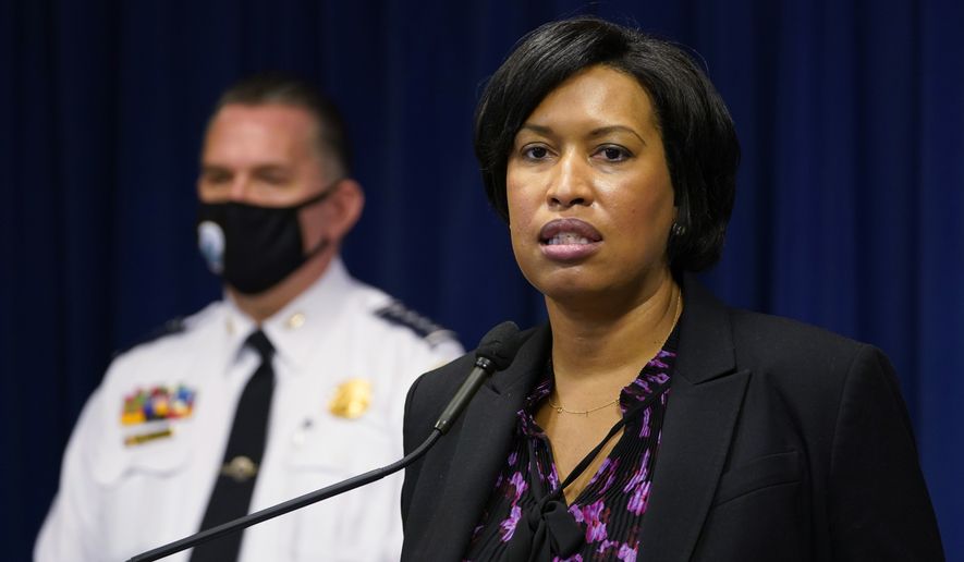 District of Columbia Mayor Muriel Bowser, right, standing next to Metropolitan Police Department chief Peter Newsham, left, speaks during a news conference in Washington, Wednesday, Nov. 4, 2020. (AP Photo/Susan Walsh)