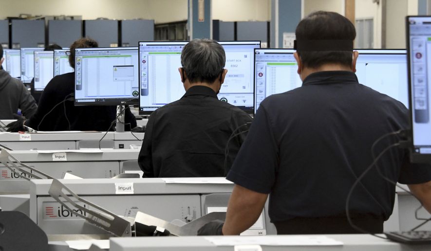 Workers count votes on election night at the Los Angele County Registrar's Tally Operations Center in Downey, Calif., Tuesday, Nov. 3, 2020. (Keith Birmingham/The Orange County Register via AP)