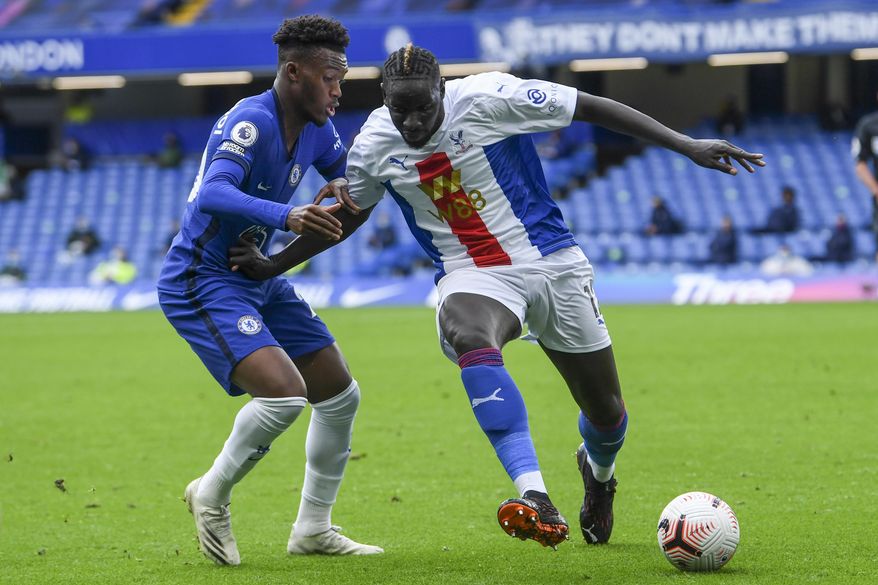Chelsea's Callum Hudson-Odoi, left, and Crystal Palace's Mamadou Sakho fight for the ball during an English Premier League soccer match between Chelsea and Crystal Palace at Stamford Bridge stadium in London, Saturday, Oct. 3, 2020. (Neil Hall/ Pool via AP)