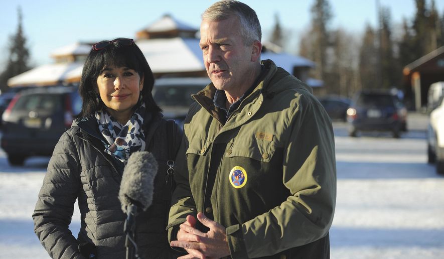 Incumbent Republican Sen. Dan Sullivan, left, with his wife Julie, speaks to the media after casting his ballot at the Alaska Zoo Tuesday, Nov. 3, 2020 in Anchorage, Alaska. (AP Photo/Michael Dinneen)