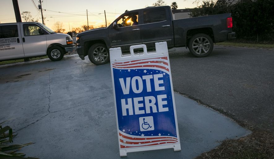 In this file photo, the sun sets as people arrive to vote at St. Paul Missionary Baptist Church in Ironton, Louisiana for Election Day on Tuesday, Nov. 3, 2020. Early voting for runoff elections in Louisiana ends on Saturday, Nov. 28, 2020. (Chris Granger/The Advocate via AP)