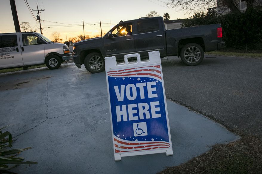 In this file photo, the sun sets as people arrive to vote at St. Paul Missionary Baptist Church in Ironton, Louisiana for Election Day on Tuesday, Nov. 3, 2020. Early voting for runoff elections in Louisiana ends on Saturday, Nov. 28, 2020. (Chris Granger/The Advocate via AP)