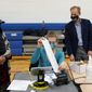 Minnesota Secretary of State Steve Simon visits with poll workers as he toured the Brian Coyle Center, on Election Day Tuesday, Nov. 3, 2020, in Minneapolis. (AP Photo/Jim Mone)