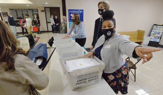 Marian Collin Franco, 20, helps collect provisional ballots at the Erie County Courthouse on Election Day, Tuesday, Nov. 3, 2020, in Erie, Pa. (Greg Wohlford/Erie Times-News via AP)