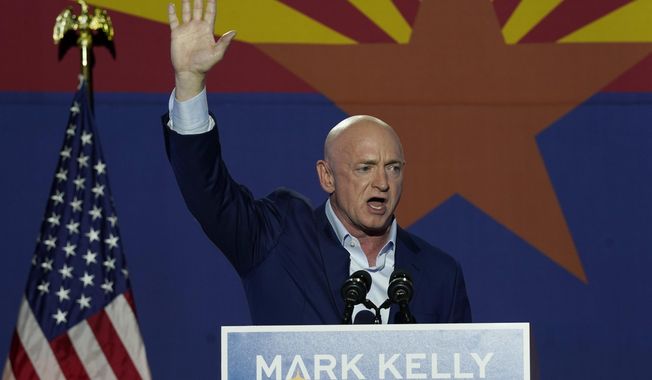 Mark Kelly, Arizona Democratic candidate for U.S. Senate, waves to supporters as he speaks during an election night event Tuesday, Nov. 3, 2020 in Tucson, Ariz. (AP Photo/Ross D. Franklin)