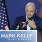 Mark Kelly, Arizona Democratic candidate for U.S. Senate, removes his mask as he prepares to speak at an election night event Tuesday, Nov. 3, 2020 in Tucson, Ariz. (AP Photo/Ross D. Franklin) **FILE**