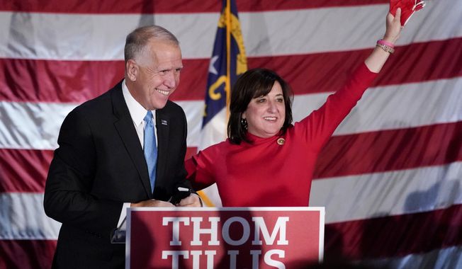 Sen. Thom Tillis, R-N.C., celebrates with his wife Susan, at a election night rally Tuesday, Nov. 3, 2020, in Mooresville, N.C. (AP Photo/Chris Carlson)