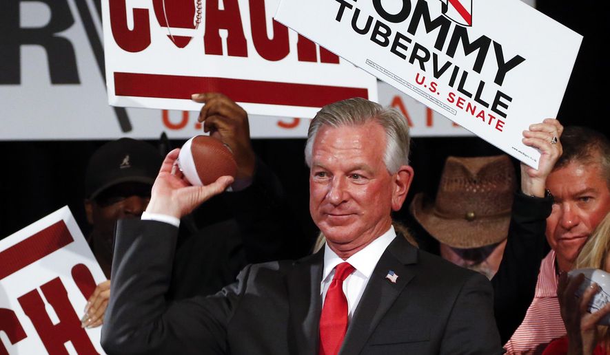 Republican Senator-elect Tommy Tuberville throws toy footballs to supporters at his watch party at the Renaissance Hotel on Tuesday, Nov. 3, 2020, in Montgomery, Ala. (AP Photo/Butch Dill)