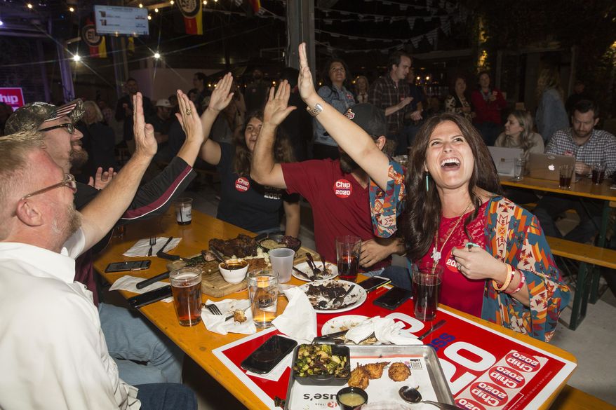 Dana Sherrod, right, celebrates with fellow Republicans while watching Election Day results on television during the Republican watch party at Krause's Cafe in New Braunfels, Texas, on Tuesday, Nov. 3, 2020. Trump has won Texas by the thinnest margin of any Republican in decades. (Mikala Compton/Herald-Zeitung via AP)