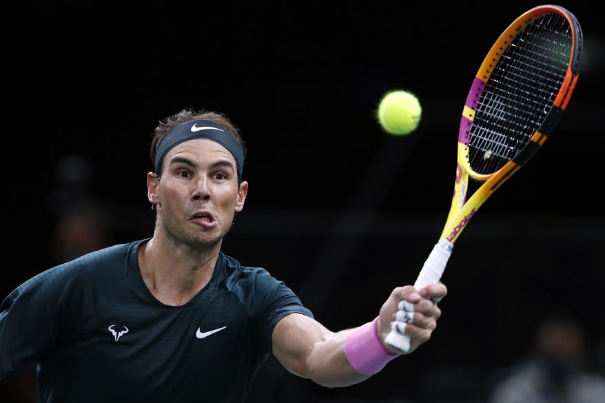Spain's Rafael Nadal returns to compatriot Feliciano Lopez during the second round of the Paris Masters tennis tournament at the Bercy Arena in Paris, Wednesday, Nov. 4, 2020. (AP Photo/Thibault Camus)