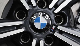 FILE - In this Feb.13, 2020 file photo, a wheel on a BMW car is on display at the 2020 Pittsburgh International Auto Show. German automaker BMW said third-quarter net profit rose 17% to 1.81 billion euros ($2.22 billion) as regional auto markets recovered and highly profitable luxury models such as the 8 Series coupe and X7 large sport-utility vehicle helped fatten the bottom line.  (AP Photo/Gene J. Puskar, File)
